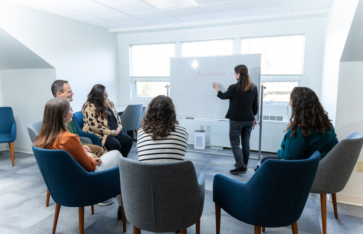 woman teaching with a white board