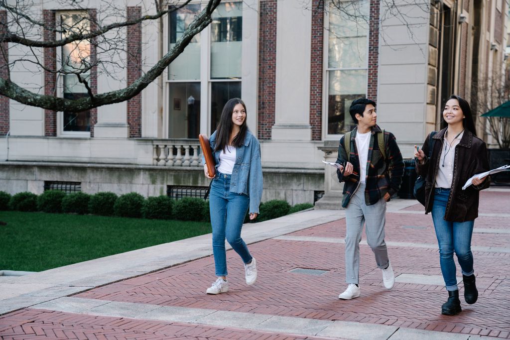 Holding On, Letting Go: Supporting Your Student With Mental Health Challenges As They Transition to College 1 Group of young people walking on a college campus holding books, ready to start the transition to college